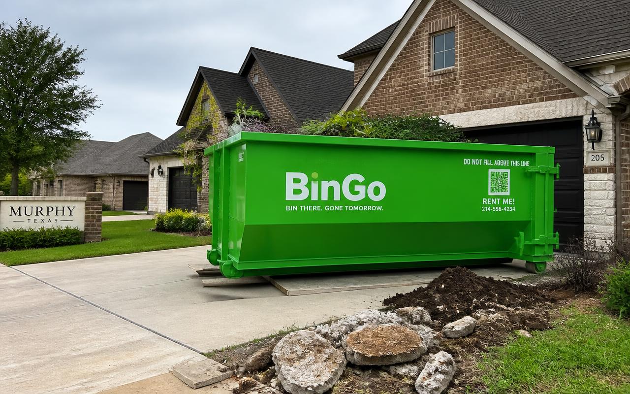 BinGo dumpster rental on a wide driveway in Murphy, TX during a landscape and hardscape tear-out